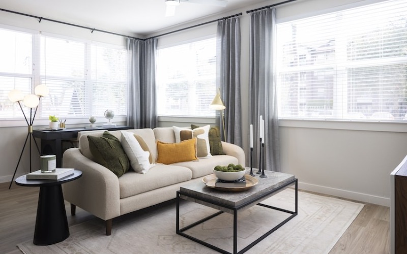 living room with large windows and couch in the middle