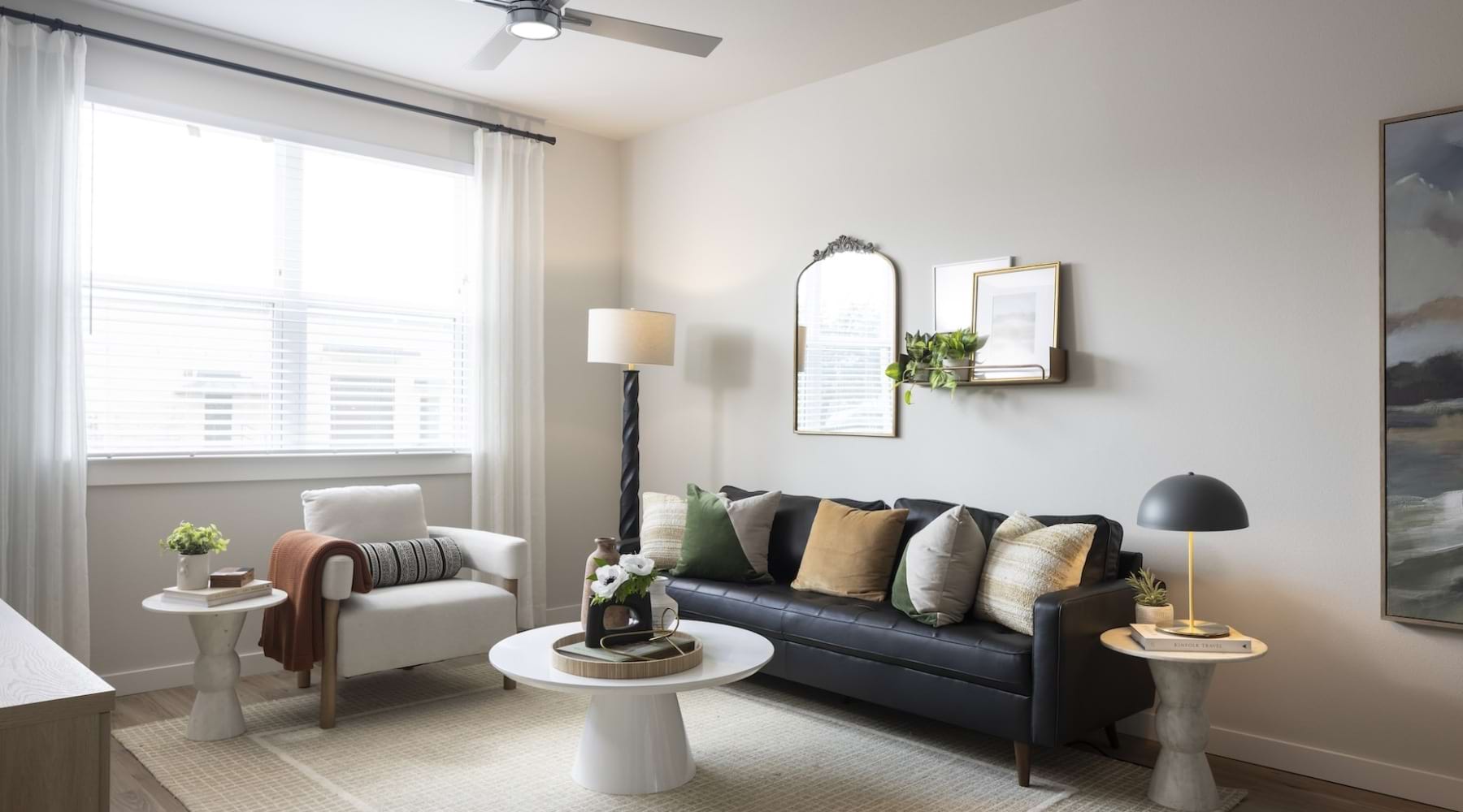 Settle into comfort at Broadstone Garden Oaks Living room with couch, large window and lamp in the corner at broadstone garden oaks in houston, tx