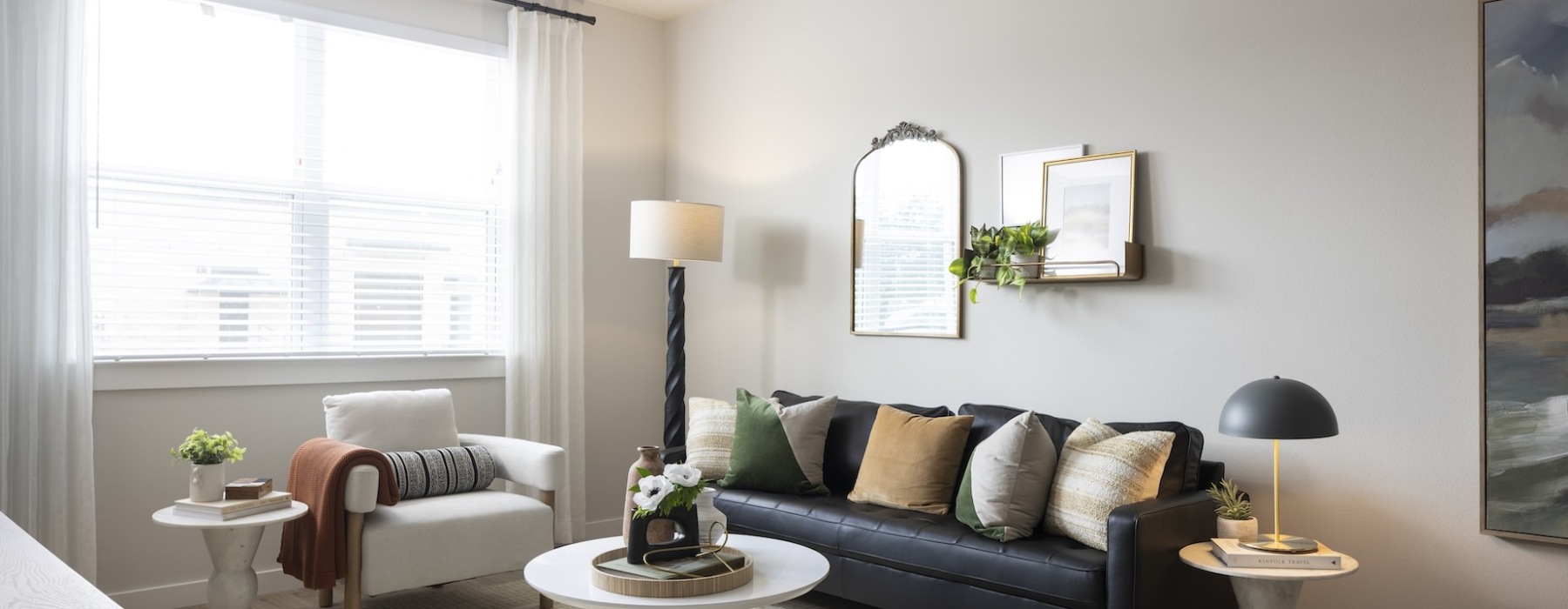 Living room with couch, large window and lamp in the corner at broadstone garden oaks in houston, tx