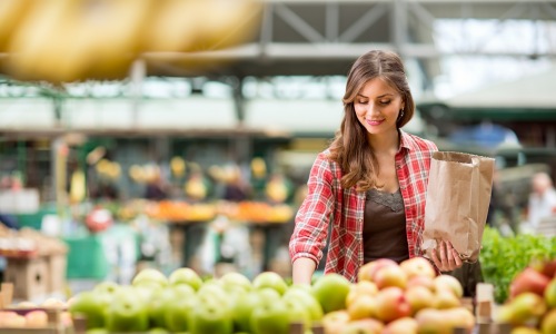 a woman shopping for fruits at HEB in Houston