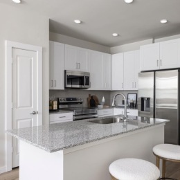 kitchen with ample counter-space, modern appliances and bright lighting